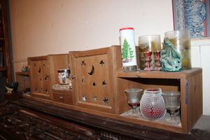 lot 51 image: Candles and Wood display shelf with star and moon cut-outs on doors.