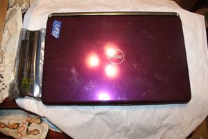 lot 82 image: Purple Dell laptop with extra unopened battery
