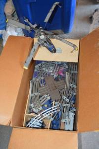 lot 173 image: Remote controlled Helicopter and model train with train tracks, plus Pogs (milk cap game from the 1990s)