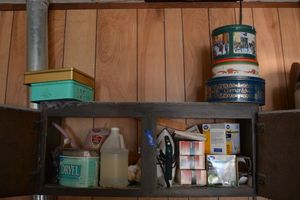 lot 181 image: Clothes iron, lightbulbs and colored flood lights, collectible tins
