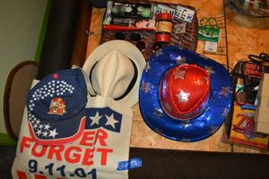 lot 153 image: Red White and blue hats, 9-11 Never Forget bag, sunglasses, earrings