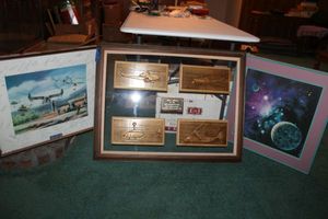 lot 214 image: Wall art - wooden Bell helicopters, Commemorative airplane poster with signatures, space poster