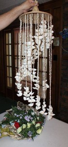 lot 216 image: Hanging shell windchime and artificial flowers