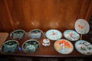lot 188 image: Collector plates - Enchanted Wings and Chinese Imperial plates. Plus Chinese paddle fan and Enchanted Wings music box