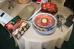 lot 287 image: Kitchen - Stoneware baking pans, Bundt and angel food cake pans, cheese grater, microwave chip maker, vintage cooking utensils, and pie plates
