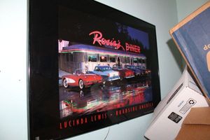 lot 295 image: Wall art Light-up Rosies Diner.  Rosies diner and car tail lights light up.