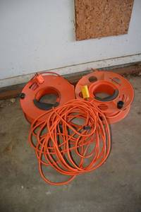lot 374 image: (3) extension cords - 2 have reels, one is missing an end