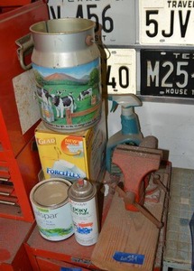 lot 384 image: Vise clamp, trash bags, milk jug and paint