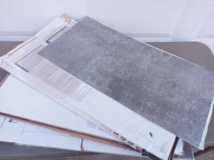lot 39 image: 3 Boxes of TrafficMaster Self-Stick Vinyl Tile - Grey 12x24 - Number of Tiles Per Box Indeterminate