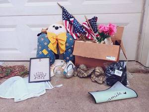 lot 56 image: Large Bulk Decoration Set Including Multiple American Flags, Burlap Live Laugh Love Photo Frame, Scarecrow, (2) Winged Angel Wall Art, Large Heart Candle Holder, Material Closet ShoeClothing Cubes, and More