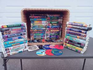 lot 18 image: Set of 44 VHS and 19 DVDCDs - Including Disneys Dumbo, Toy Story, Bambi, Pocahontas, and The Dev Invitation, Twisted Late Bloomers, and Much More