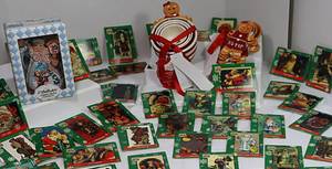 lot 24 image: Christmas Measuring Cups and Spoons, Collectible Figurine, Trading Cards, and More.