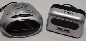 lot 62 image: Two electric clocks. One AMFM Radio Alarm and the other provides alarms as well as USB charge ports.