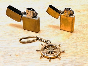lot 29 image: Two Vintage Solid Brass Zippo Lighters &amp Brass Ships Wheel Key Chain