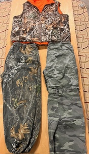 lot 224 image: Four (4) Piece Camo - Including 2XL Real Tree Reversible Sleeveless Coat, Size 42 Dickies and Wrangler Shorts, & Warm-Up Bottoms
