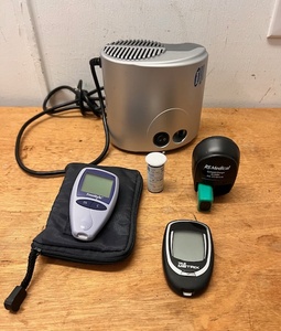 lot 291 image: Medical Electronics Lot - Including Stratos Compact Nebulizer, Freestyle and True Metrix Blood Sugar Testers, & RS Medical Compact Charger