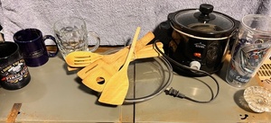 lot 365 image: Miscellaneous Kitchen Lot - Including Six (6) New Wooden Cooking Utensils, Rival Crockpot, Themed Coffee Mugs, &amp Glass Pie Plate