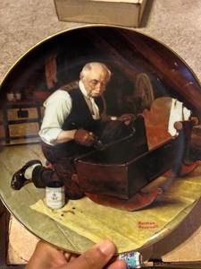 lot 241 image: Norman Rockwell plate collection qty 4-- Grandpas gift # 1484K- The music maker # T3689- The light house keepers daughter # 00671X- The ship builder # 22581K,  Dreaming in the Attic  #12271