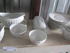 lot 36 image: Genuine porcelain dishes, butter dish, 9 saucers, gravy boat, 2 coffee cups, sugar dish, creamer dish