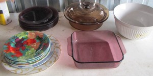 lot 58 image: Covered brown baking dish, Purple dinner plates and saucers, white salad bowl, purple oven dish and more