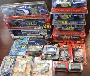 lot 87 image: NASCAR Jimmie Johnson Number 48 Collectible Cars Including Three 164 Scale Trailer