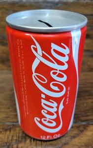 lot 105 image: Vintage Collectible Coke Cola Coin Bank with Coins Weighing at 260 Grams