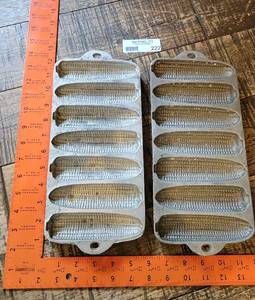 lot 222 image: Two Vintage Cast Aluminum Seven Stick Corn Cob Shaped Corn Muffin Pans