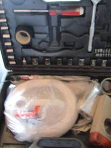 lot 59 image: Roadside emergency kit- tools, zip ties, electrical tape, jug and more