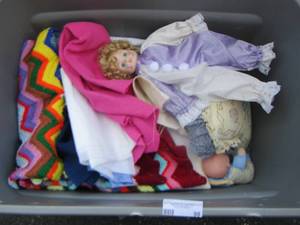 lot 98 image: quilts and fabric and dolls