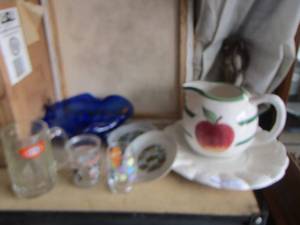 lot 132 image: A&W Root beer mug, blue glass bowl, decorative cup plates, apple handled pitcher and more