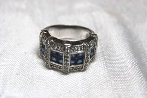 lot 31 image: Sterling Silver - Ring Marked 925 RP Size 8 weighs 12g. Features Blue and clear rhinestones