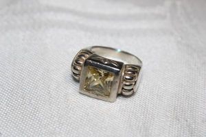 lot 33 image: Sterling Silver - Features a Yellow stone, marked 925 size 6.5 weighs 7g