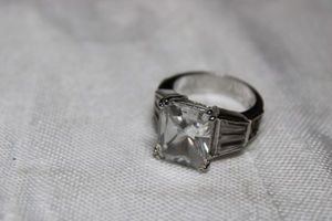 lot 37 image: Sterling Silver - marked 925 Features large clear square stone, size 5 weighs 7g