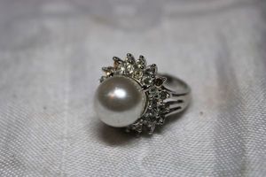 lot 47 image: Sterling Silver - Silver tone Ring with pearl Marked 925, some rhinestones missing.