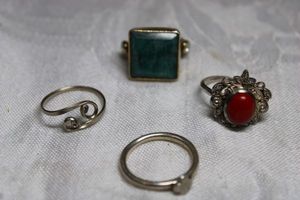 lot 48 image: Sterling Silver - 4 times the money. Red stone ring marked P 925, some are unmarked