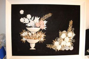 lot 22 image: Framed Art work made from whole and broken shells on brown felt background