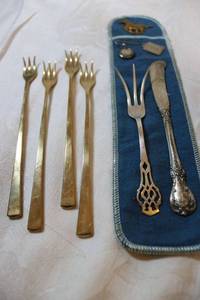 lot 18 image: 4 Shrimp forks marked Dirilyte, Sterling Silver fork and butterknife, and Misc. metals