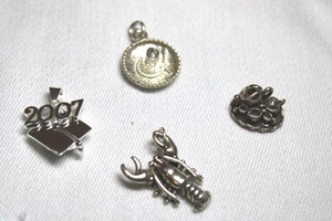 lot 87 image: Sterling Silver - pendant selection with lobster, sombrero, tea set and 2007 grad