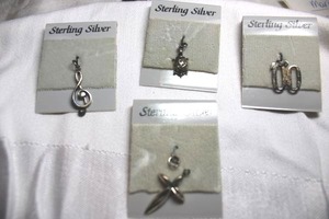 lot 90 image: Sterling Silver - pendant selection with cross, turtle, 00, and treble chef sign