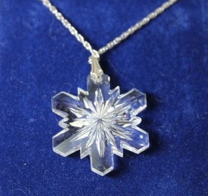 lot 104 image: Sterling Silver - Clear Snowflake pendant on silver chain marked Sterling
