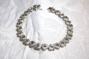 lot 106 image: Sterling Silver - String of hearts bracelet with box clasp, marked 925 weight 11.8g