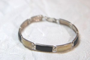 lot 111 image: Sterling Silver - Silver panel link bracelet with black and cream enamel