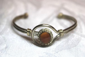 lot 113 image: Sterling Silver - Bangle bracelet with brown stone, weight 13.1g