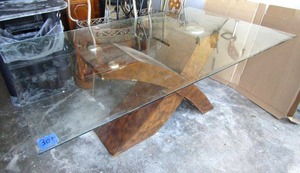 lot 304 image: Designer glass top table with unique X theme wood base. (PLEASE BRING HELP TO LOAD)