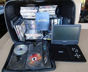lot 305 image: Assorted DVD movies various titles and genres, generous quantity, includes Sylvania portable DVD player (No cord)