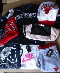 lot 314 image: Dallas Cowboys and Chicago Bulls apparel some with store tags attached plus FILA bags