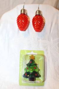 lot 293 image: (2) Illuminated jewelry pieces. Includes large 3L red bulb ear wire earrings and holiday tree broochpin, 2.5H. Both functional and light up.