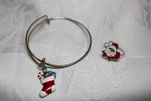 lot 298 image: Expandable charm bracelet with enamel stocking charm and enamel Santa adjustable ring.