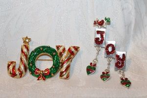 lot 275 image: (2) Enamel JOY broochespins Joy with ornament dangles 2W x 2H, Joy with wreath pin 1.5H x 2W