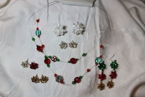 lot 276 image: Happy Holidays wire necklace and (5) sets of figural bow earrings (1 ear wire, 4 poststud).